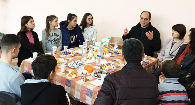 GFC staff member, Joe Bednarek, speaking with a group of young people in Moldova