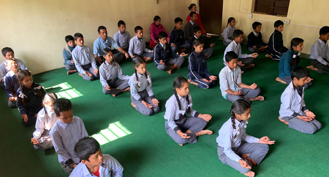 Children participating in a meditation and mindfulness activity.